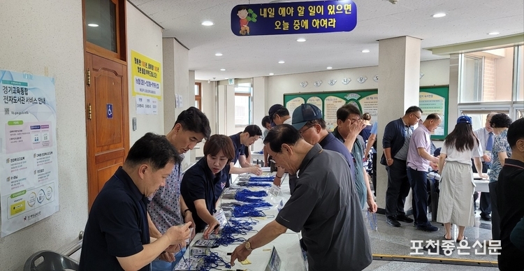 추진위원회 준비위원들이 동문 지급용 명찰을 확인하고 있다.